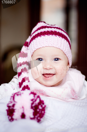 Image of cute baby in a hat with pompom