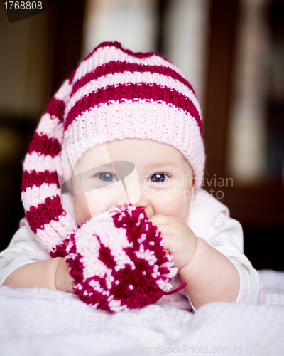 Image of cute baby in a hat with pompom