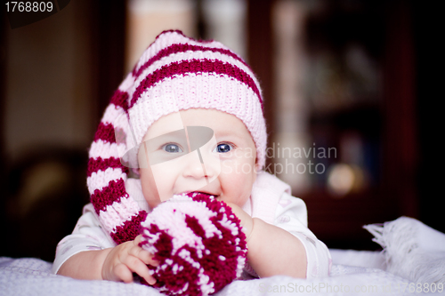 Image of cute 6 month baby holding a bobble in her hands