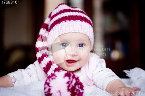 Image of cute happy baby in a striped hat with bobble