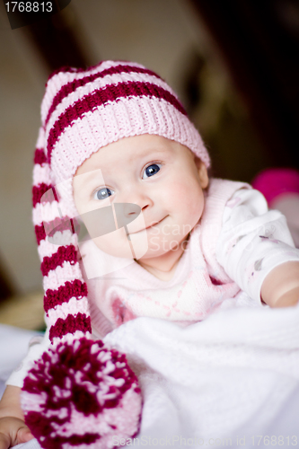 Image of cute baby in a hat with pompom