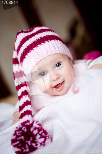 Image of cute baby in a hat with pompom