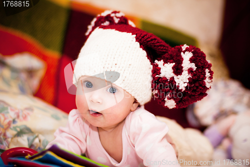 Image of cute little baby in wool hat with pompoms