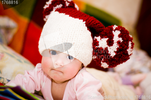 Image of cute little baby in wool hat with pompoms