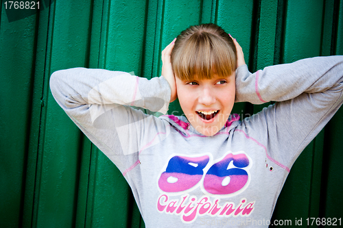 Image of teenage girl hiding from noise