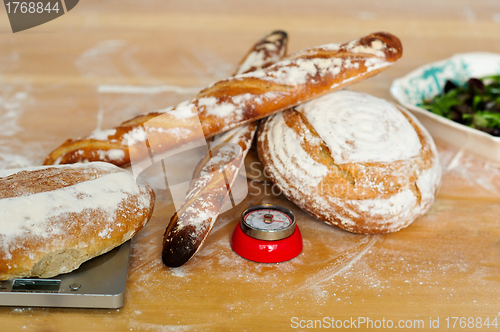 Image of Baguettes and breads on wooden table