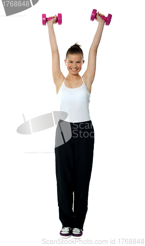 Image of Young girl exercising with dumbbells