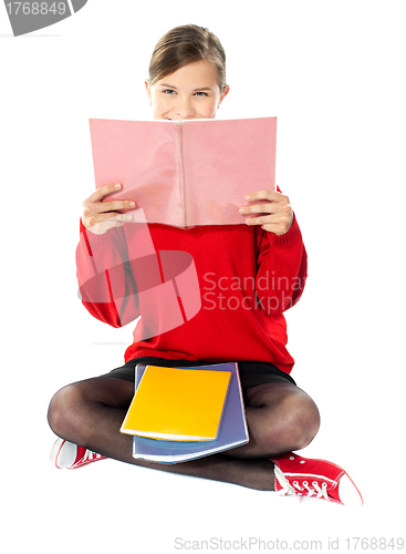 Image of Girl sitting with books on her lap