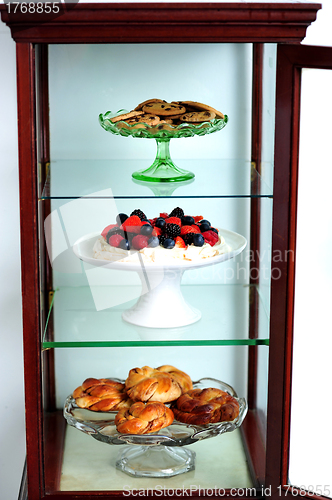Image of Shelf decorated by delicious desserts