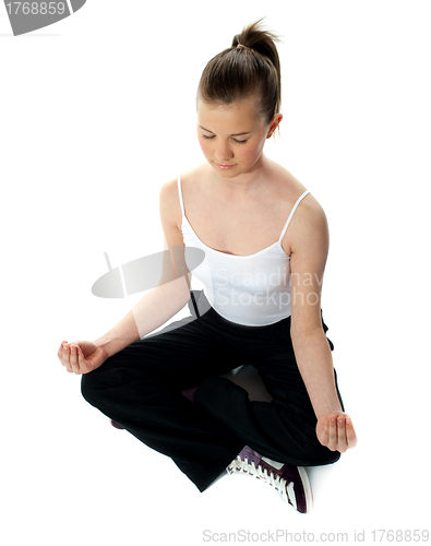 Image of Aerial view of meditating girl