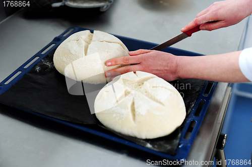 Image of Female cutting dough in a creative manner