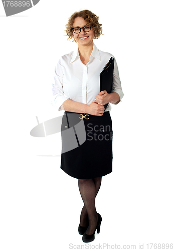 Image of Female executive holding clipboard. Isolated