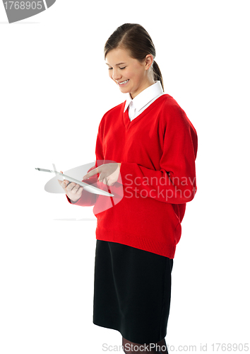 Image of Beautiful teenage using electronic tablet