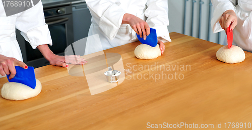 Image of Women hands kneading dough