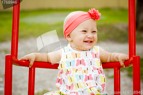 Image of Cute little girl on the swings