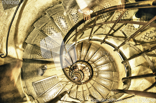 Image of Spiral Staircase with People Moving