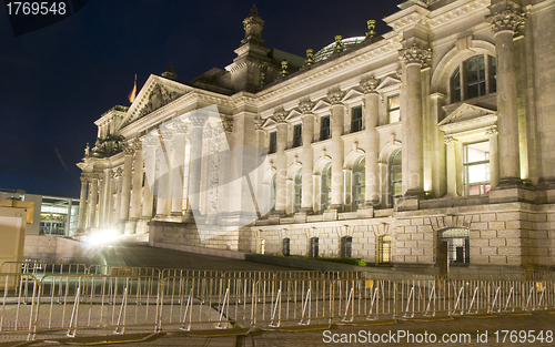 Image of  Reichstag Parliament building main entrance flags blowing night