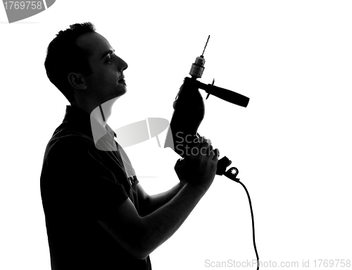 Image of Silhouette of man with drilling machine