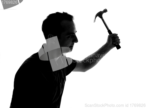 Image of Silhouette of a man working with hammer