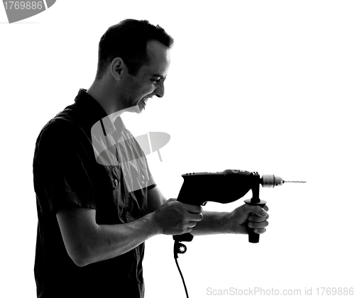 Image of Silhouette of man with drilling machine