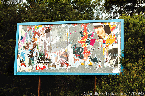 Image of Billboard with old torn posters 