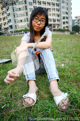 Image of Chinese girl playing grasses
