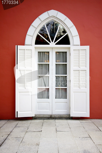 Image of White door on red wall background