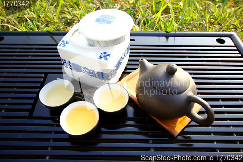 Image of Asian tea set on grasses