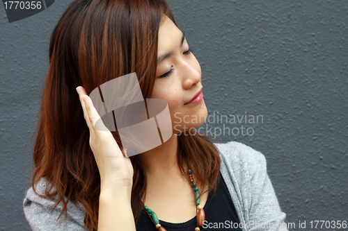Image of Asian woman hearing voice