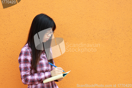Image of Asian woman reading and studying