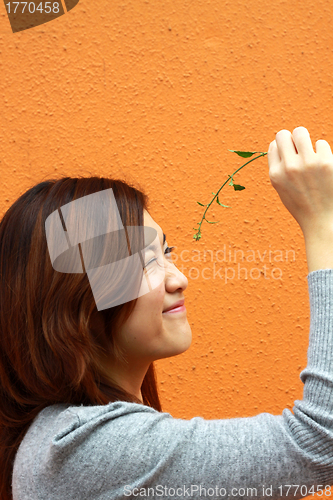 Image of Chinese girl playing grasses