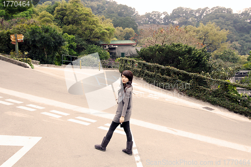 Image of Stylish asian woman in a park
