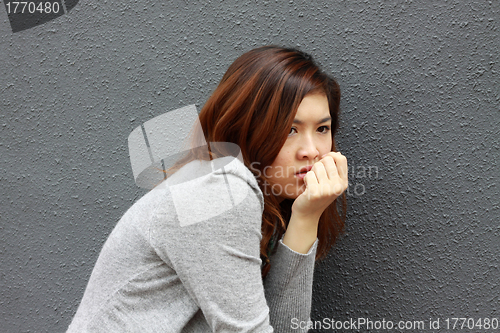Image of Asian woman with frightened face