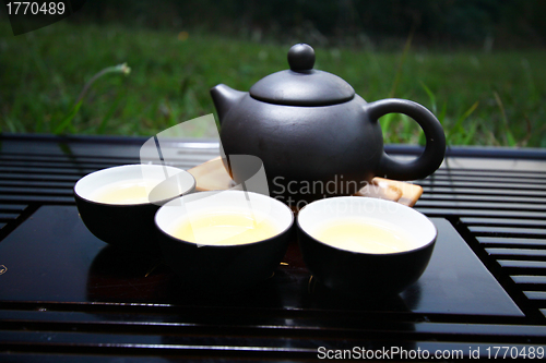 Image of Chinese tea set on grasses