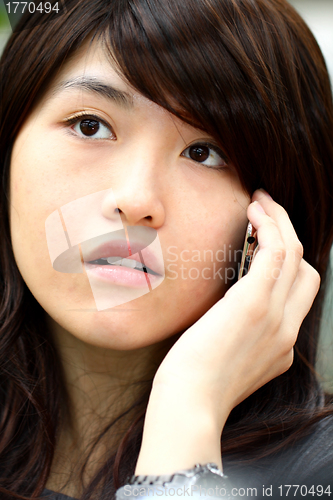 Image of Asian woman talking phone