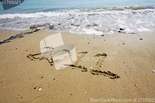 Image of 2011 written on sand