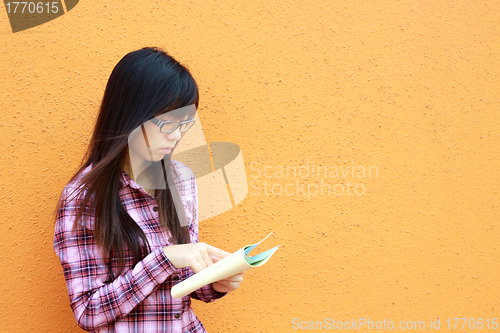 Image of Asian woman reading and studying