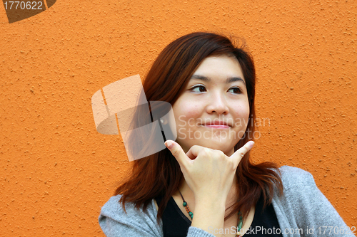 Image of Asian woman pretending to call phone