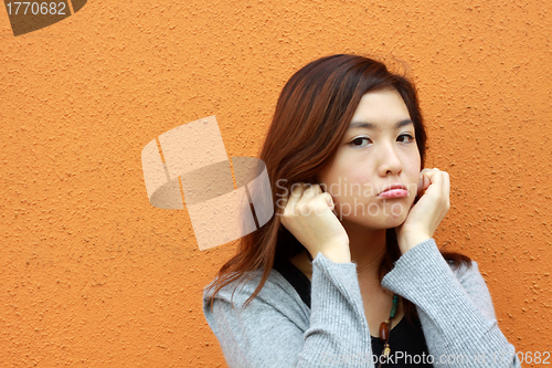 Image of Asian woman doing something wrong