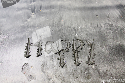 Image of Happy words on sand