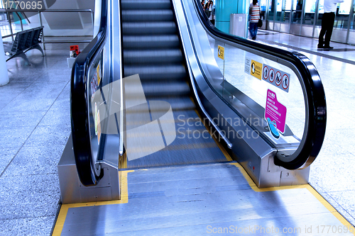 Image of Moving escalator in blue tone