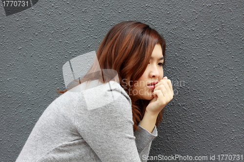 Image of Asian woman with frightened face