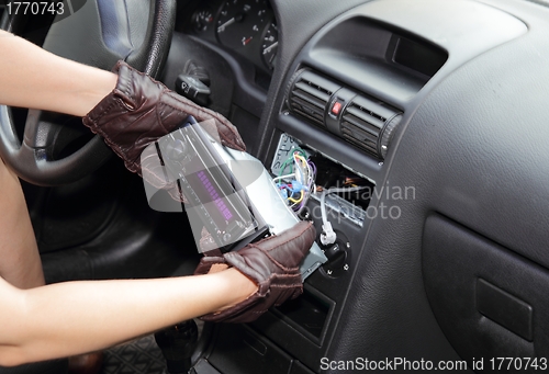 Image of Thief stealing a car radio