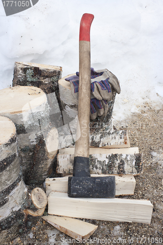 Image of Ax, a pile of birch firewoods and glove