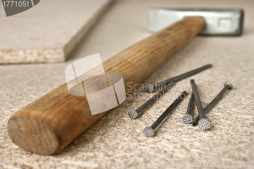 Image of Hammer and a handful of nails