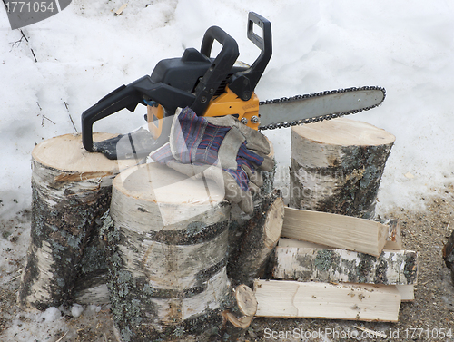 Image of Firewood and a chainsaw