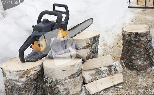 Image of Firewood and chainsaw