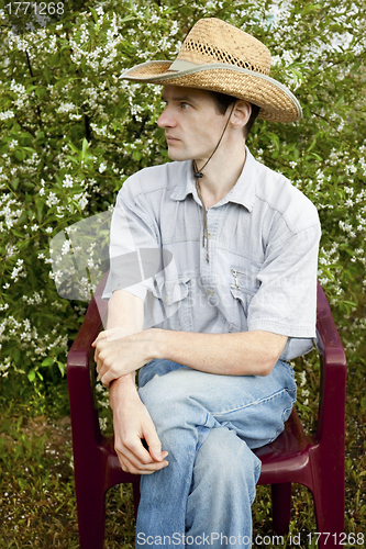 Image of A young man in a cherry garden