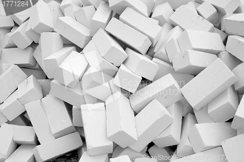 Image of A large pile of white silicate bricks