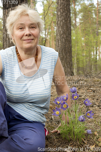 Image of An elderly woman in the forest springtime